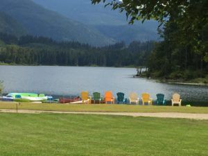 Lake shore with plenty of chairs to relax.